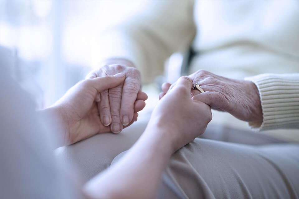 Holding elderly person's hands 