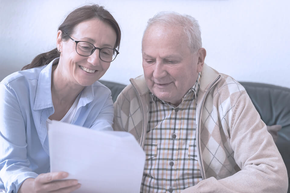 Image of woman reading a report to an elderly man