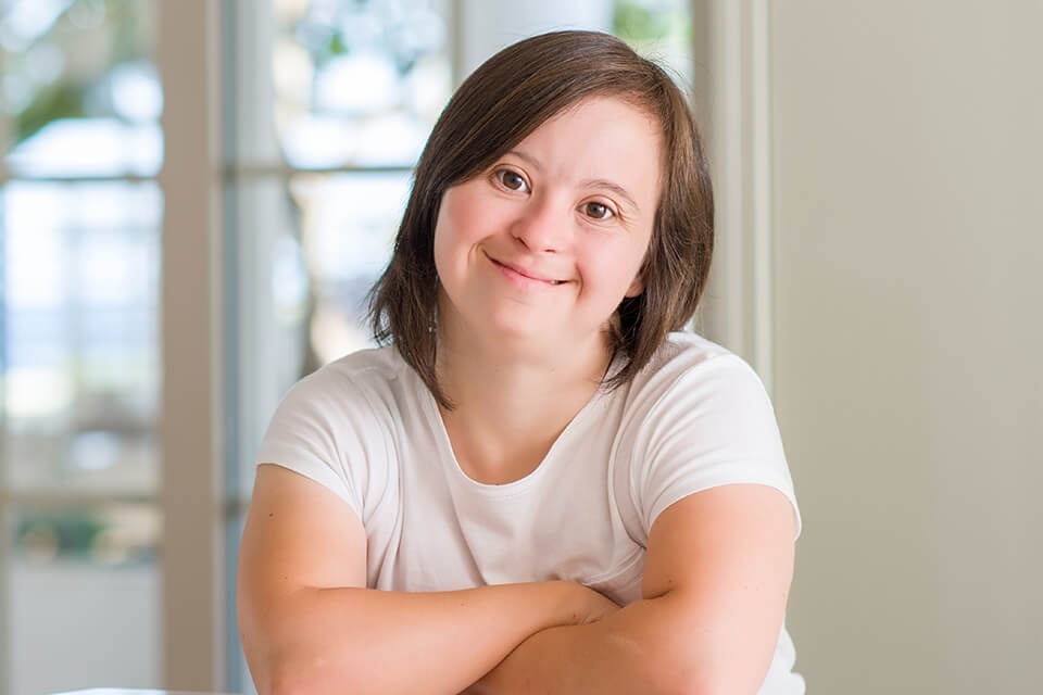 A young woman with Down syndrome smiling